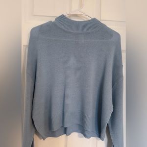 Divided blue knit sweater.